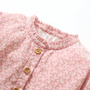 Close-up of a pink floral shirt with buttons on a white background, Obroi
