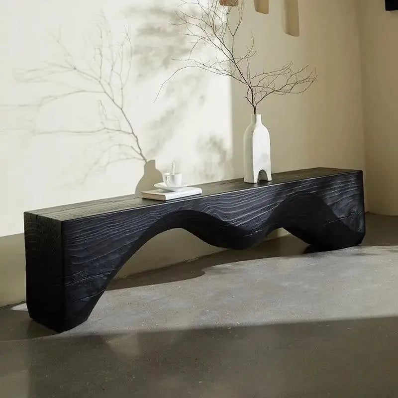 Modern black wavy coffee table with decorative items in a minimalistic room, Obroi 