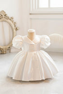 White dress on a mannequin with a decorative background, Obroi