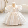 White dress on a mannequin with a decorative background, Obroi