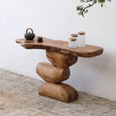 Wooden console table with rustic design against a white wall, Obroi