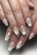 Nails with decorative gold and silver designs on a neutral background, Obroi
