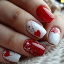 Close-up of a hand with red and white nail polish featuring heart designs, Obroi