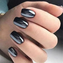 Hand with black nail polish on a neutral background, Obroi