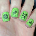 Green plaid nail art with black four-leaf clover and 'Lucky' on a hand, Obroi