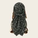 Black floral headscarf on a plain background, Obroi