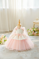 A toddler girl's formal dress displayed on a dress form mannequin. The dress features a white lace bodice with pink satin bows, a matching pink tulle underskirt, and a sheer pink veil, Obroi