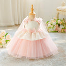 A toddler girl's formal dress displayed on a dress form mannequin. The dress features a white lace bodice with pink satin bows, a matching pink tulle underskirt, and a sheer pink veil, Obroi