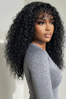 Woman with long, curly black hair wearing a gray top against a neutral background, Obroi