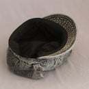 Textured fabric pet bed with black interior on a beige background, Obroi