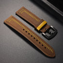 Brown leather watch strap with yellow stitching on a gray surface ,Obroi