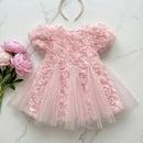 Pink floral dress on a marble surface with flowers and a headband, Obroi