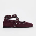 Burgundy flat shoes with silver straps and studs on a white background, Obroi