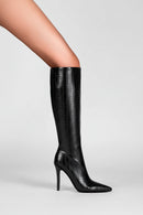 Black knee-high boot on a light gray background, Obroi