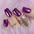 Hand with purple nails and multiple rings on a pink fur background, Obroi