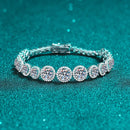 Silver bracelet with round diamonds on a teal background