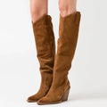 Brown knee-high boots on a white , Obroi