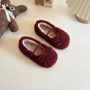 Pair of maroon slippers with a teddy bear toy on a light surface, Obroi