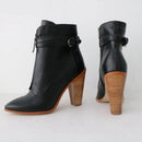 Black ankle boots with wooden soles on a white background, featuring the brand 'Obroi'.