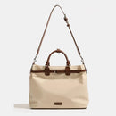 Beige handbag with brown accents on a white background, Obroi