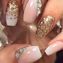 Close-up of a hand with decorative nails featuring gold glitter and opal stones, Obroi