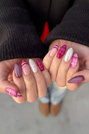 Close-up of hands with pink and white nail designs, Obroi