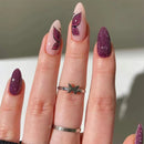 Nails with pink and purple designs on a neutral background obroi