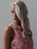 Woman wearing a pink floral dress against a gray background, Obroi