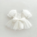 White tulle dress with puff sleeves on a light gray background, Obroi