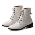 White patent leather boots with black soles on a white background, Obroi