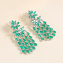 Green teardrop earrings on a beige background, Obroi