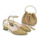 Gold glittery shoes and matching handbag on a white background, Obroi
