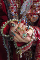 Hand adorned with colorful jewelry in a close-up shot, Obroi