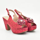 A pair of red platform slingback heels with gold floral embroidery, rhinestone embellishments, and pearl flower accents on the front, shown against a plain white background, Obroi