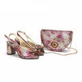 Pair of high-heeled shoes and matching handbag with floral design on a white background, featuring the brand 'Obroi'.