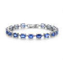 Silver bracelet with blue gemstones on a white background, featuring the brand 'TBJ Beyond Precision'.