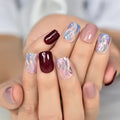 Nails with a gradient design transitioning from pink to red on a blurred background, Obroi