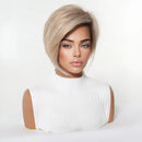 A woman wearing a short, layered wig with a side-swept bang and subtle blonde-to-brown ombré highlights, styled on a mannequin bust against a clean white studio background, Obroi