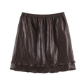 A dark brown faux-leather mini skirt with an elastic waistband and a ruffled hem, shown flat against a white background, Obroi