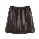A dark brown faux-leather mini skirt with an elastic waistband and a ruffled hem, shown flat against a white background, Obroi