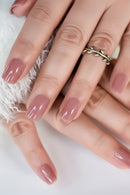 Close-up of hands with pink glittery nail polish on a soft white background, Obroi