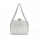 Silver beaded handbag with chain strap on a white background, brand 'Obroi' visible.