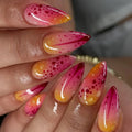Close-up of a hand with pink and orange gradient nails featuring red dots, Obroi