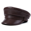 Brown leather cap with textured pattern on a white background, featuring the brand 'Obroi'.