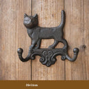 Decorative wall hook shaped like a cat on a wooden background, Obroi