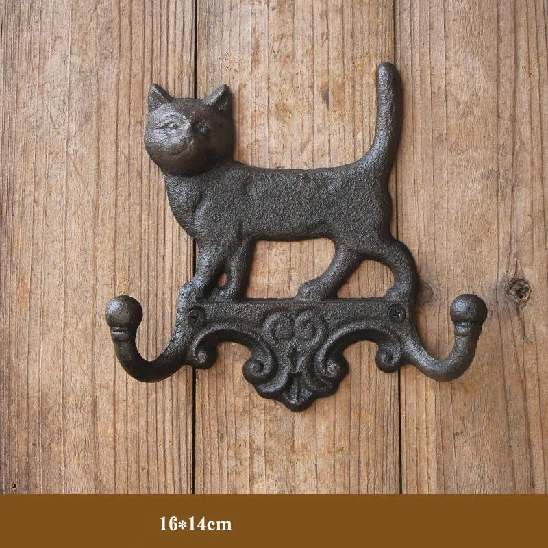 Decorative wall hook shaped like a cat on a wooden background, Obroi