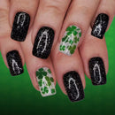 Nails with black glitter and green shamrock designs on a green background, Obroi