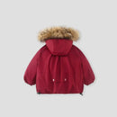 A red hooded winter parka jacket shown from the back, featuring a fluffy tan faux-fur trimmed hood and two front flap pockets with snap buttons, photographed on a light gray background, Obroi