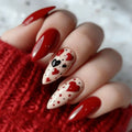 Nails with heart and black heart designs on a red textured background, Obroi
