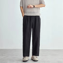 Person wearing a striped shirt and black pants on a plain background, Obroi